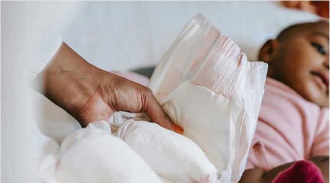 Adult changing baby's diaper
