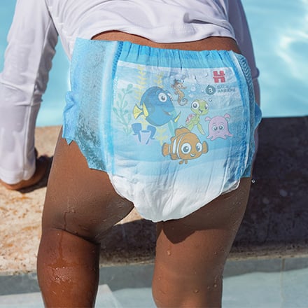 Baby wearing Huggies® Little Swimmers® Disposable Swim Pants