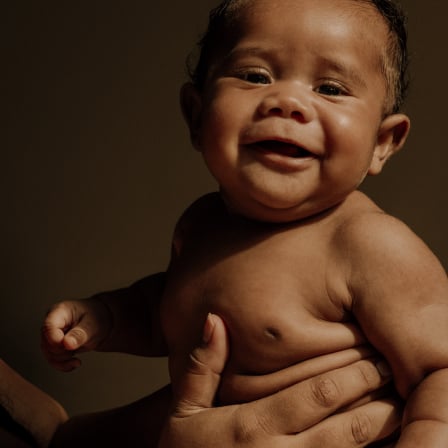Baby boy playing with Huggies® wipes, the #1 branded baby wipe