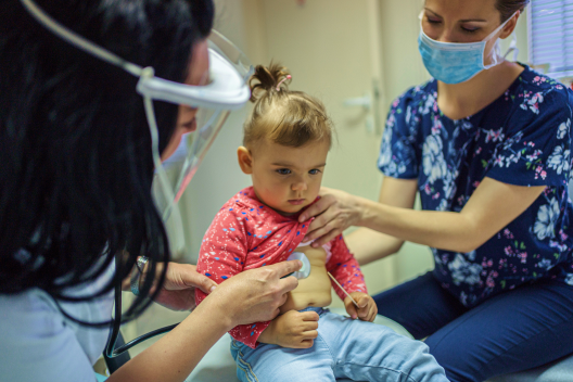 Doctors checking the health of the toddler