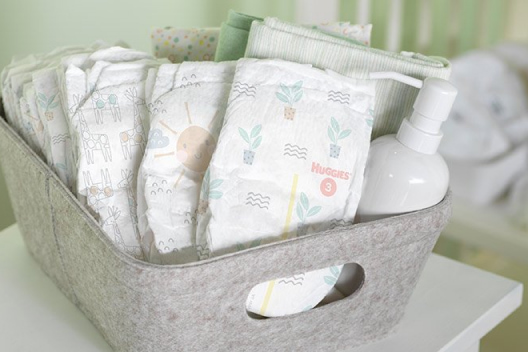 An assortment of Huggies Special Delivery Diaper designs in a gray tote
