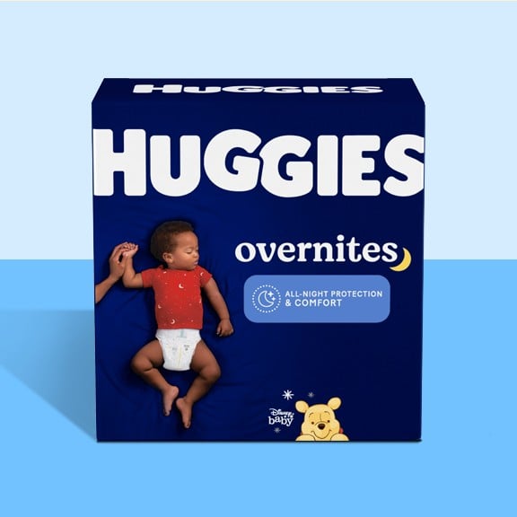 A box of Huggies Overnites night time diapers on a blue background